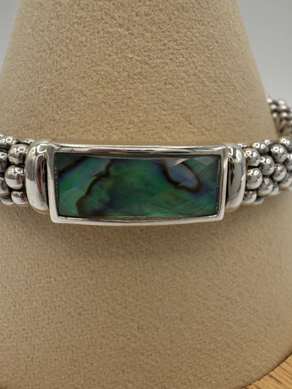 A sterling silver rope bracelet by Lagos with an iridescent abalone doublet.
